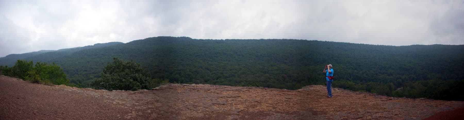 A long view over a wooded Ozark valley from a sandstone ledge