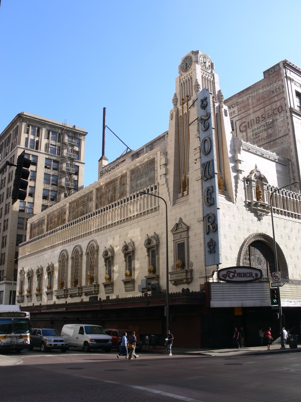 Tower Theatre clocktower, ornate facade and marquee at a downtown Los Angeles street corner.