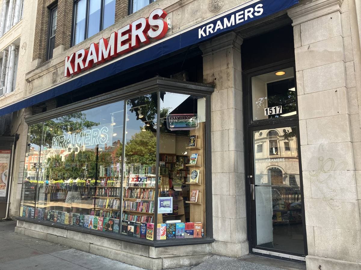 A corner bookshop with a red sign reading Kramers and books in the windows