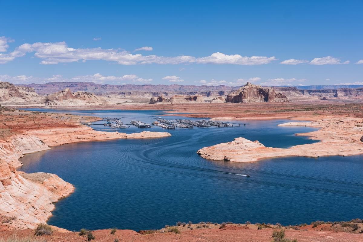 Blue lake water between pale sandstone shores