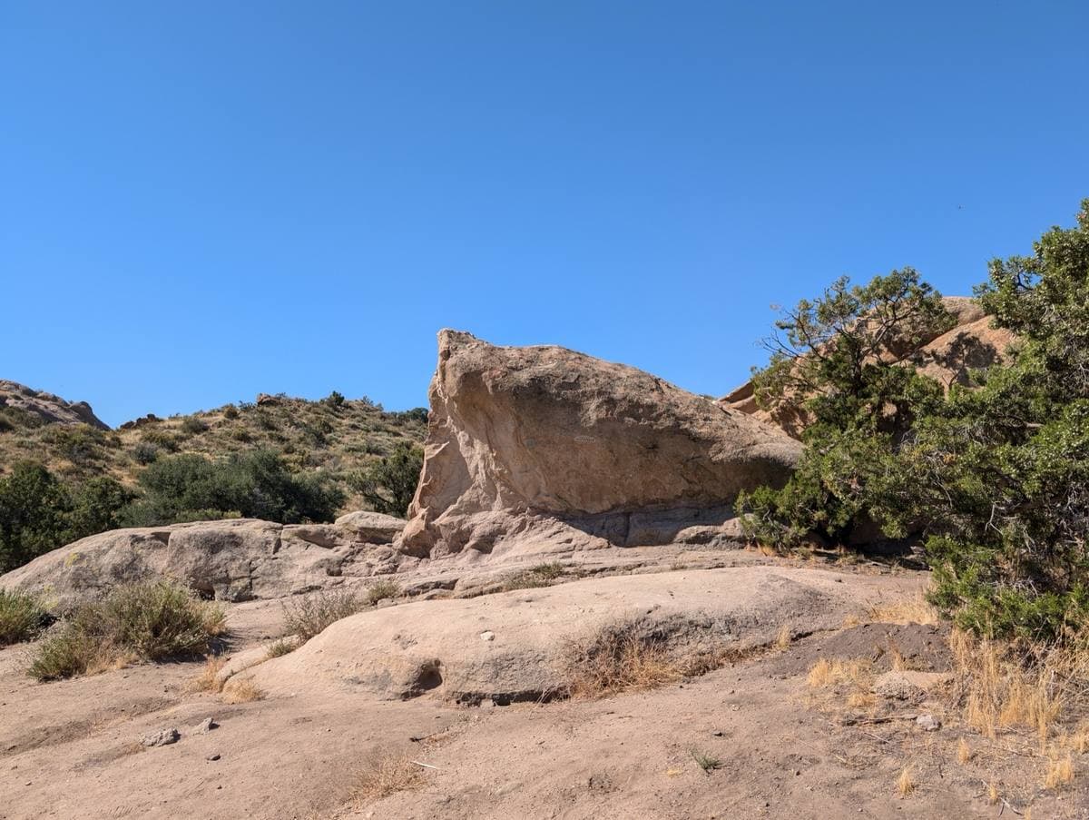Tilted sandstone slabs above scrub