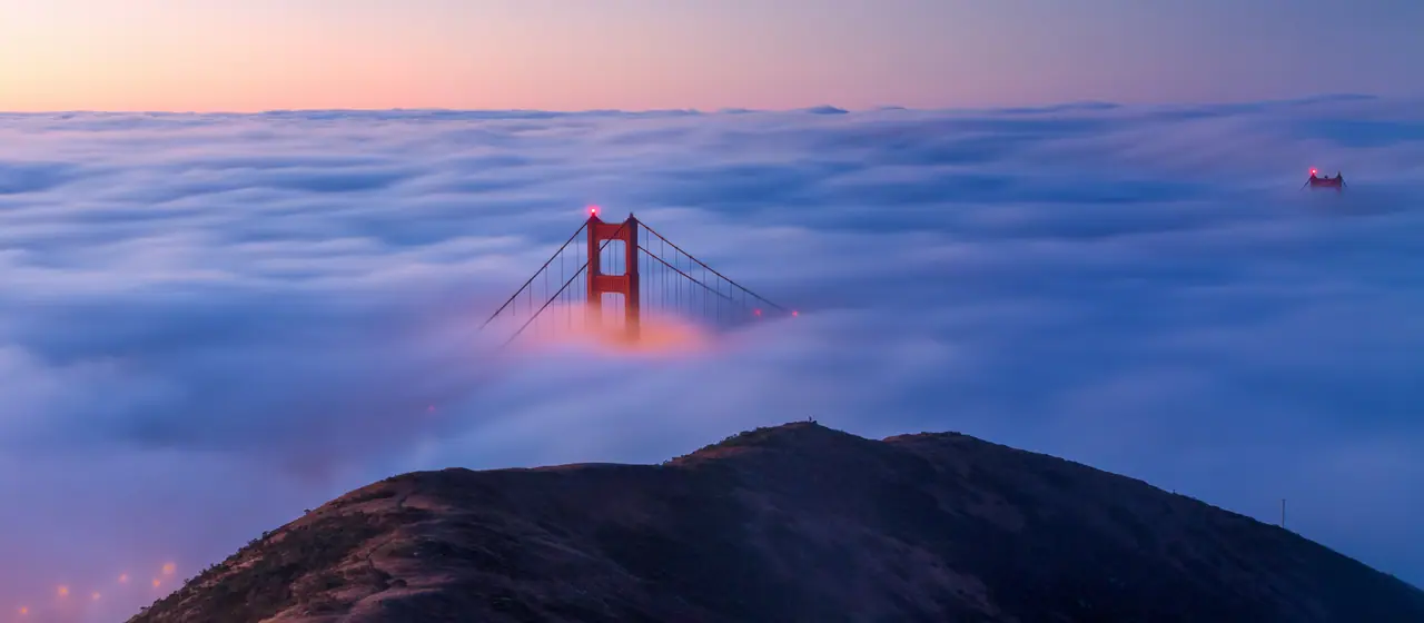 The Golden Gate Bridge rising out of the fog