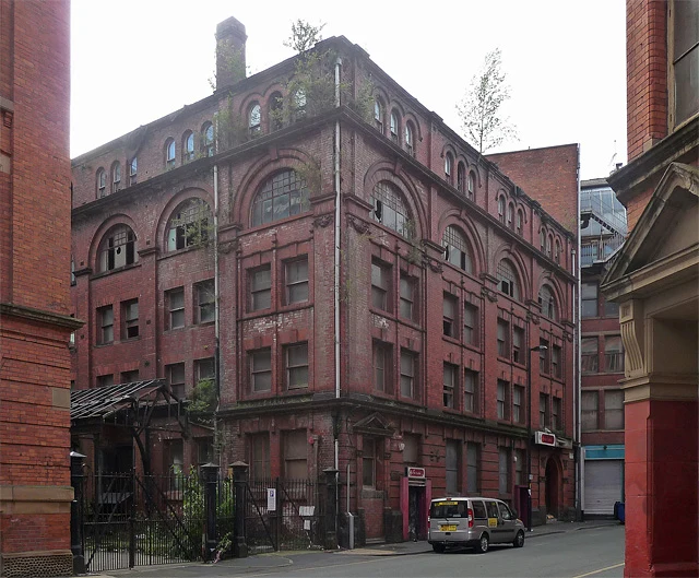 Historic brick building at 2 Harter Street and parked vehicle, photographed2011.