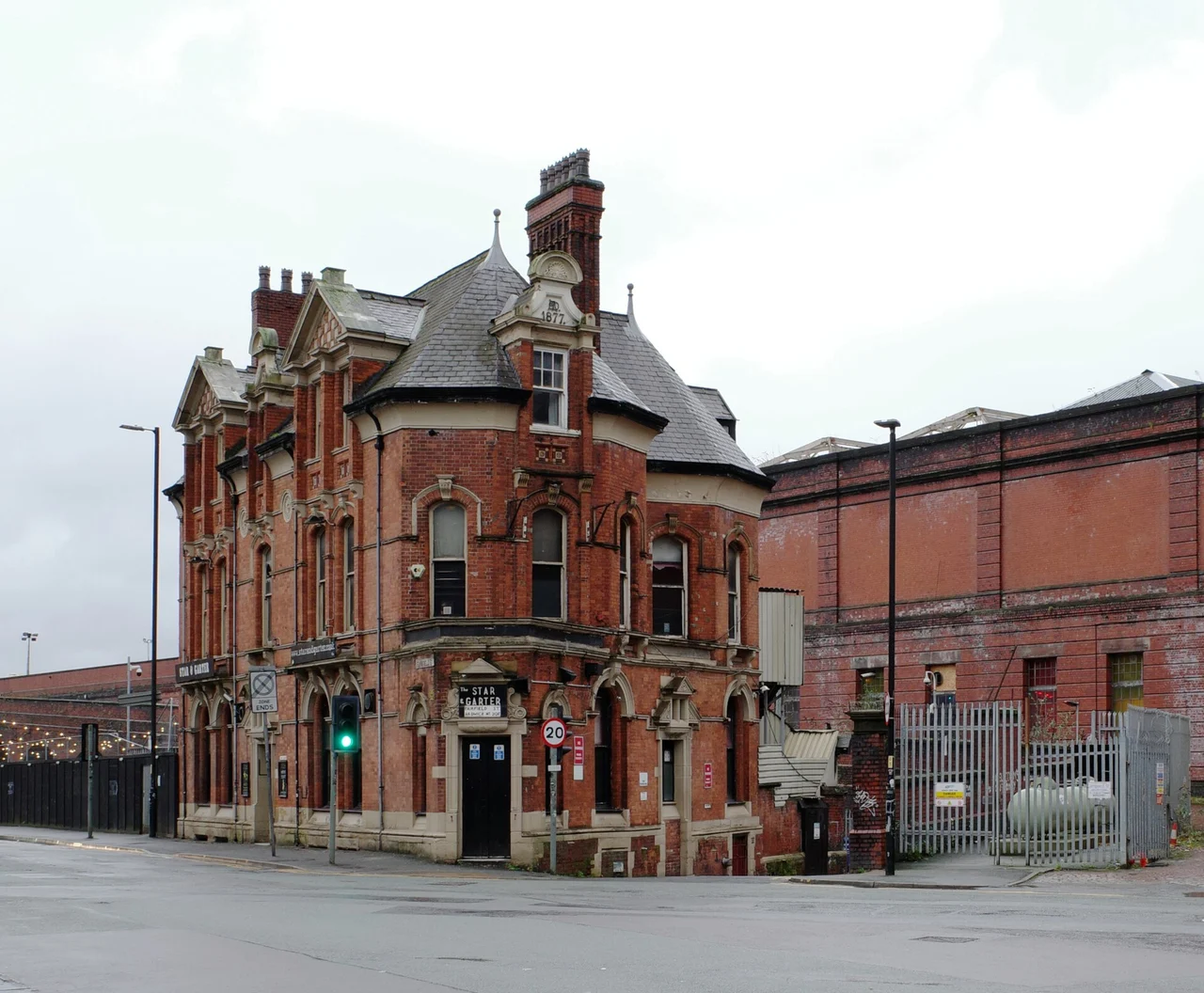 Historic red-brick Star and Garter pub exterior beside the railway viaduct