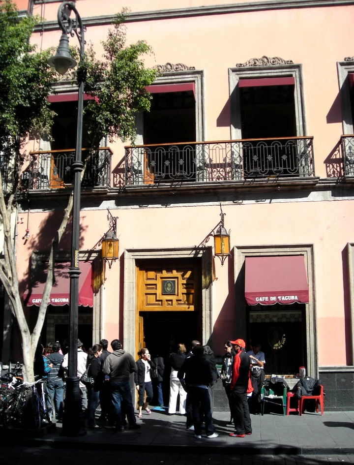 Café de Tacuba’s pink historic frontage with burgundy named awnings and people outside, January2011