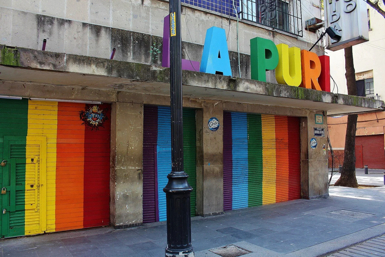 Closed rainbow-painted shutters beneath the LA PURI letters on República de Cuba street during the 2021 pandemic closure