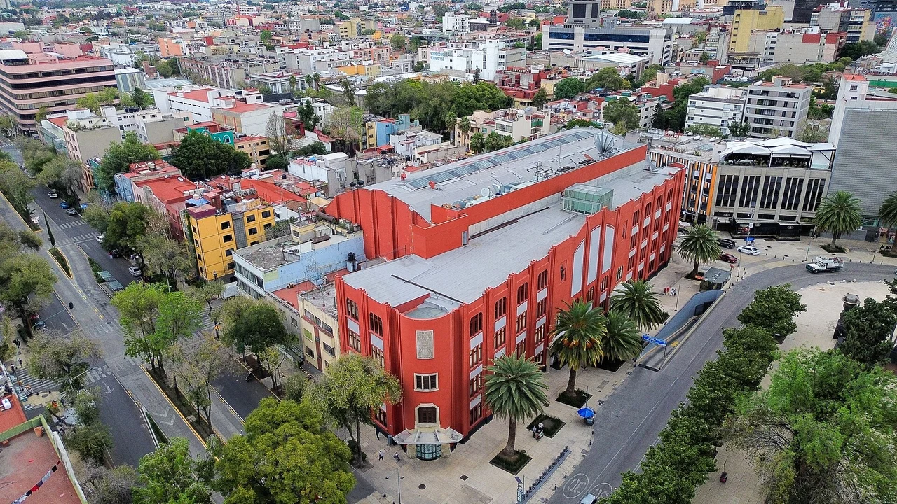 Elevated view of the red Frontón México building and surrounding streets
