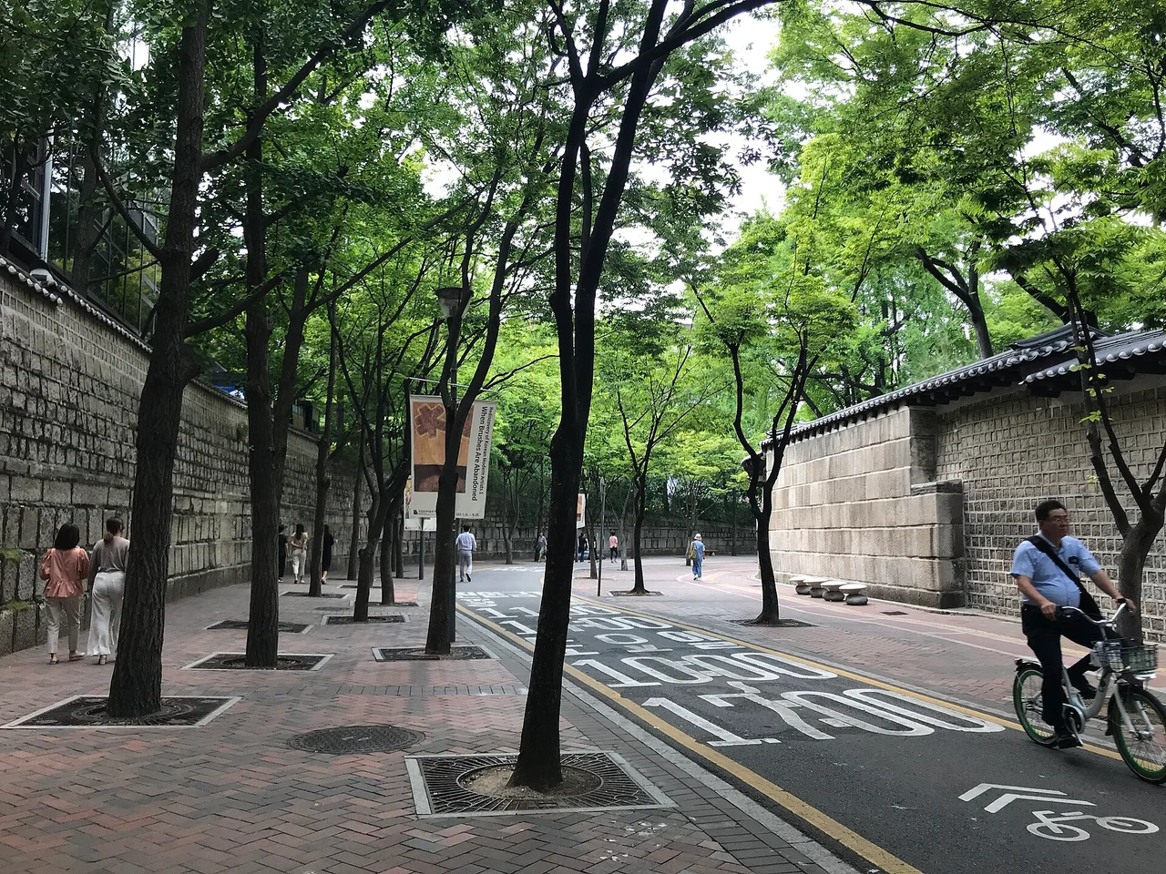 Tree-lined Jeongdong-gil street beside stone walls in 2019