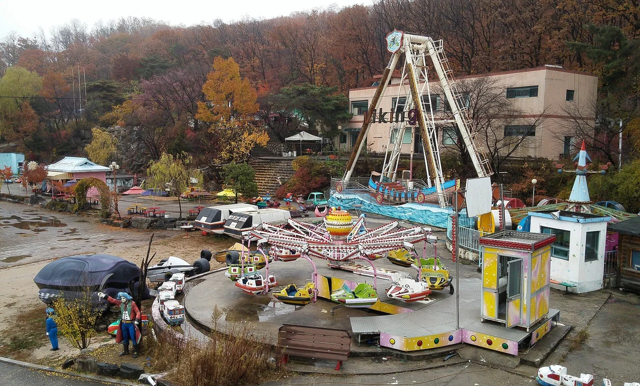 Retained rides, a Viking swing ship and park buildings at Yongma Land on an autumn day in 2015