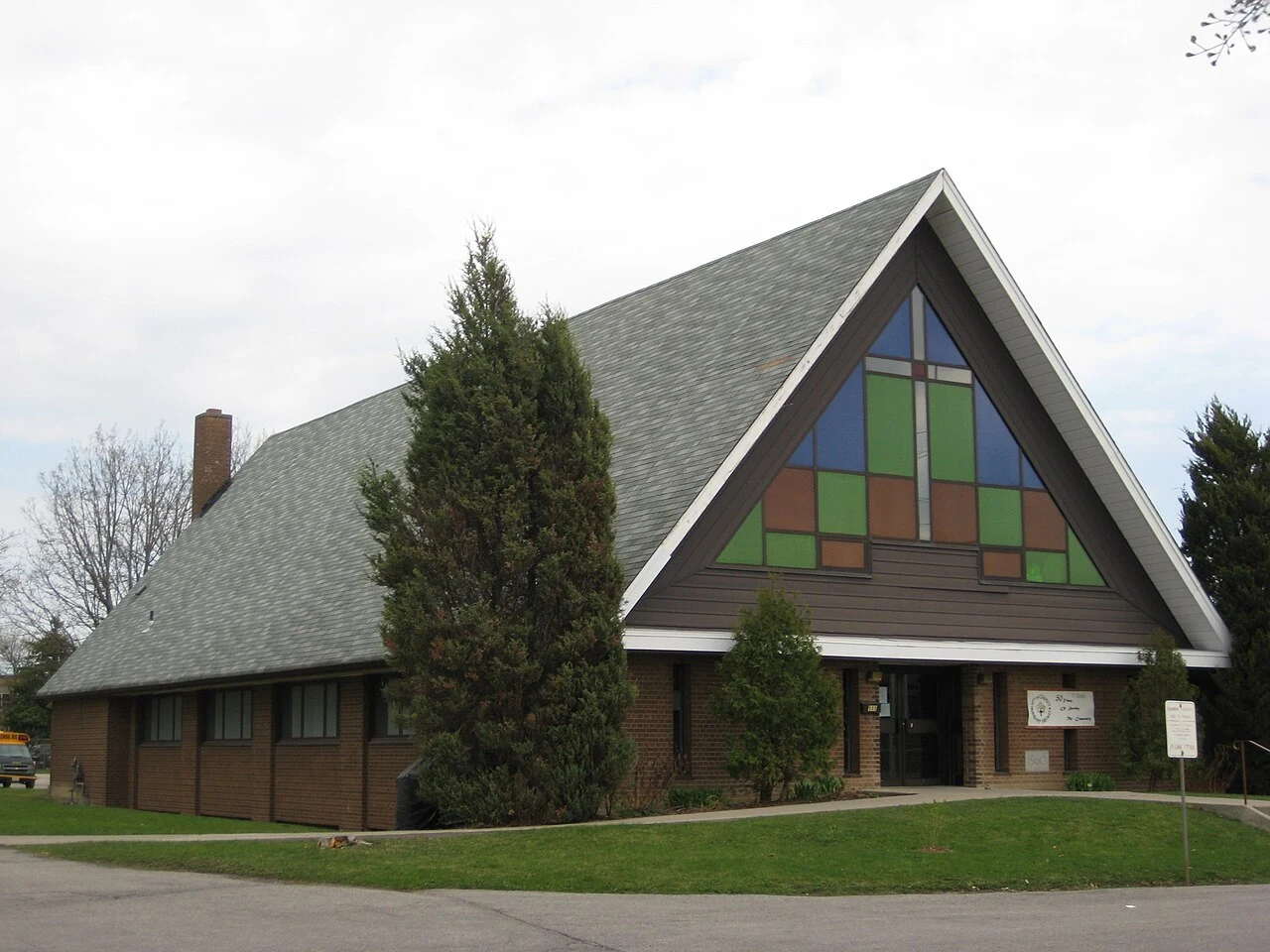 Saint Theodore of Canterbury church exterior with an A-frame roof and colored facade windows