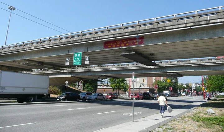 The Georgia Viaduct crossing above Main Street, with roadway and pedestrians below.
