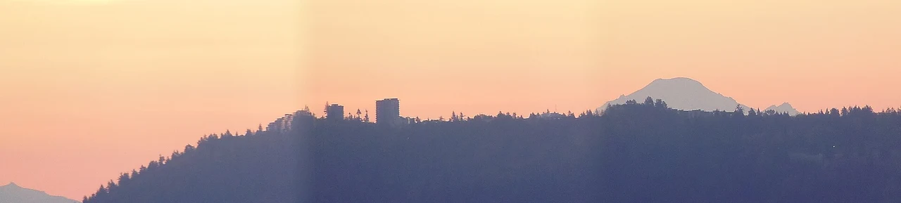 Simon Fraser University on the distant foreground ridge, with Mount Baker behind at dawn