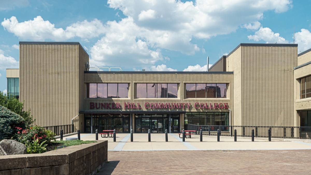 The tan main building of Bunker Hill Community College under a summer sky