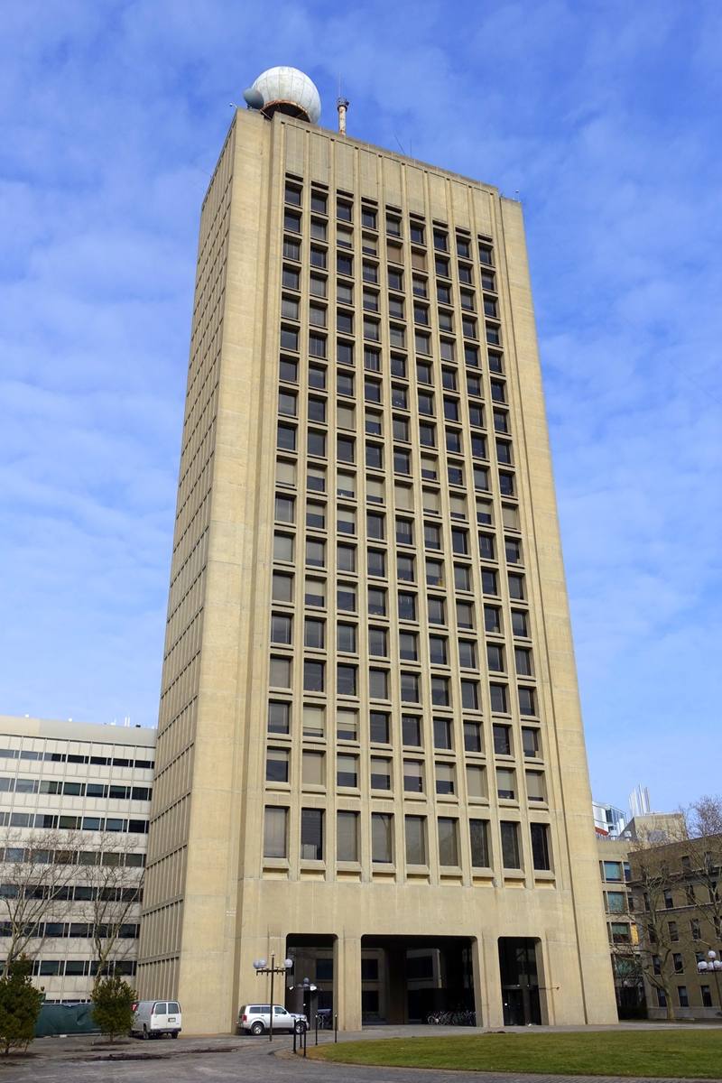 A tall concrete tower with a white dome on its roof