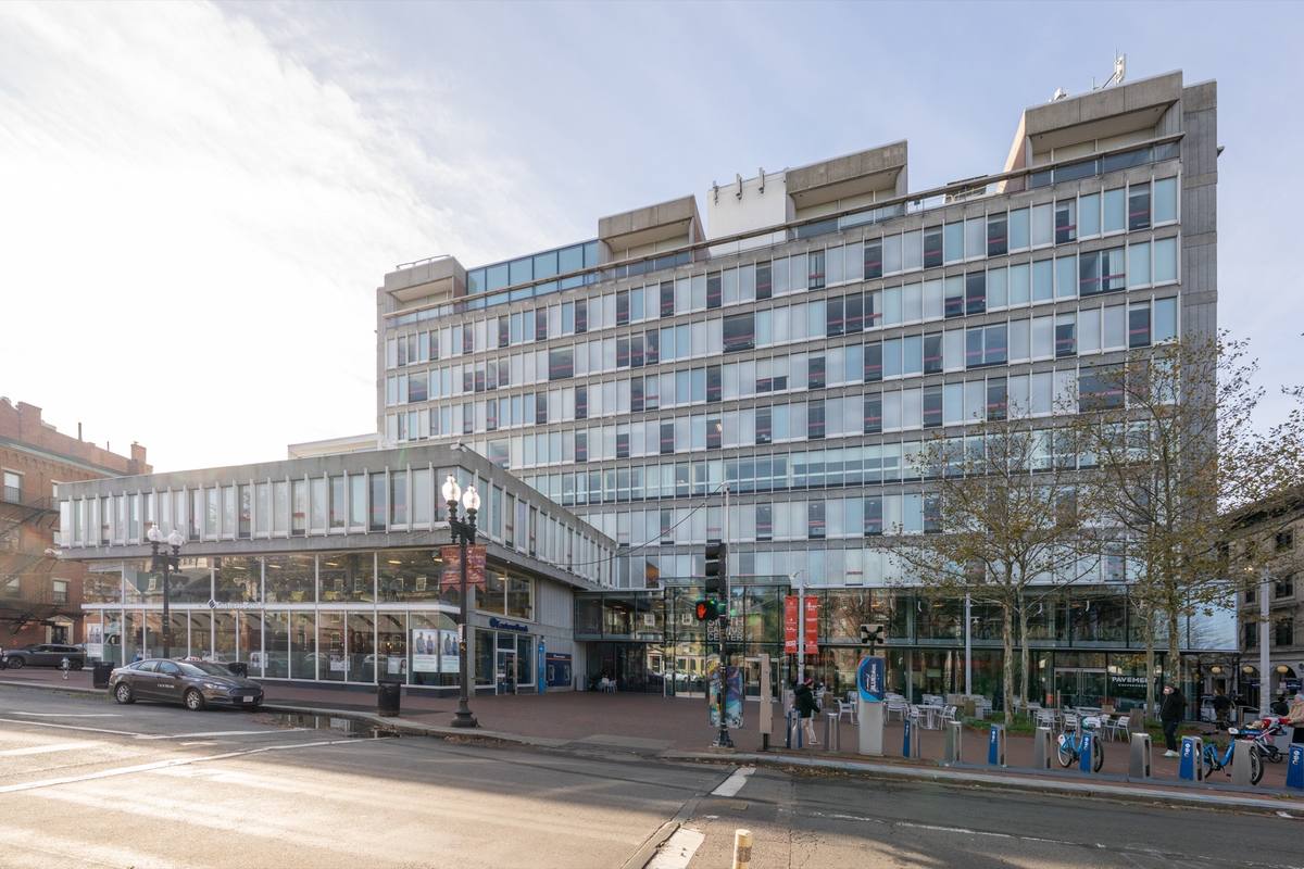 A glass and concrete building on Massachusetts Avenue at Harvard Square