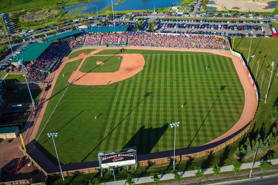 Aerial view of a baseball stadium with striped grass and full stands