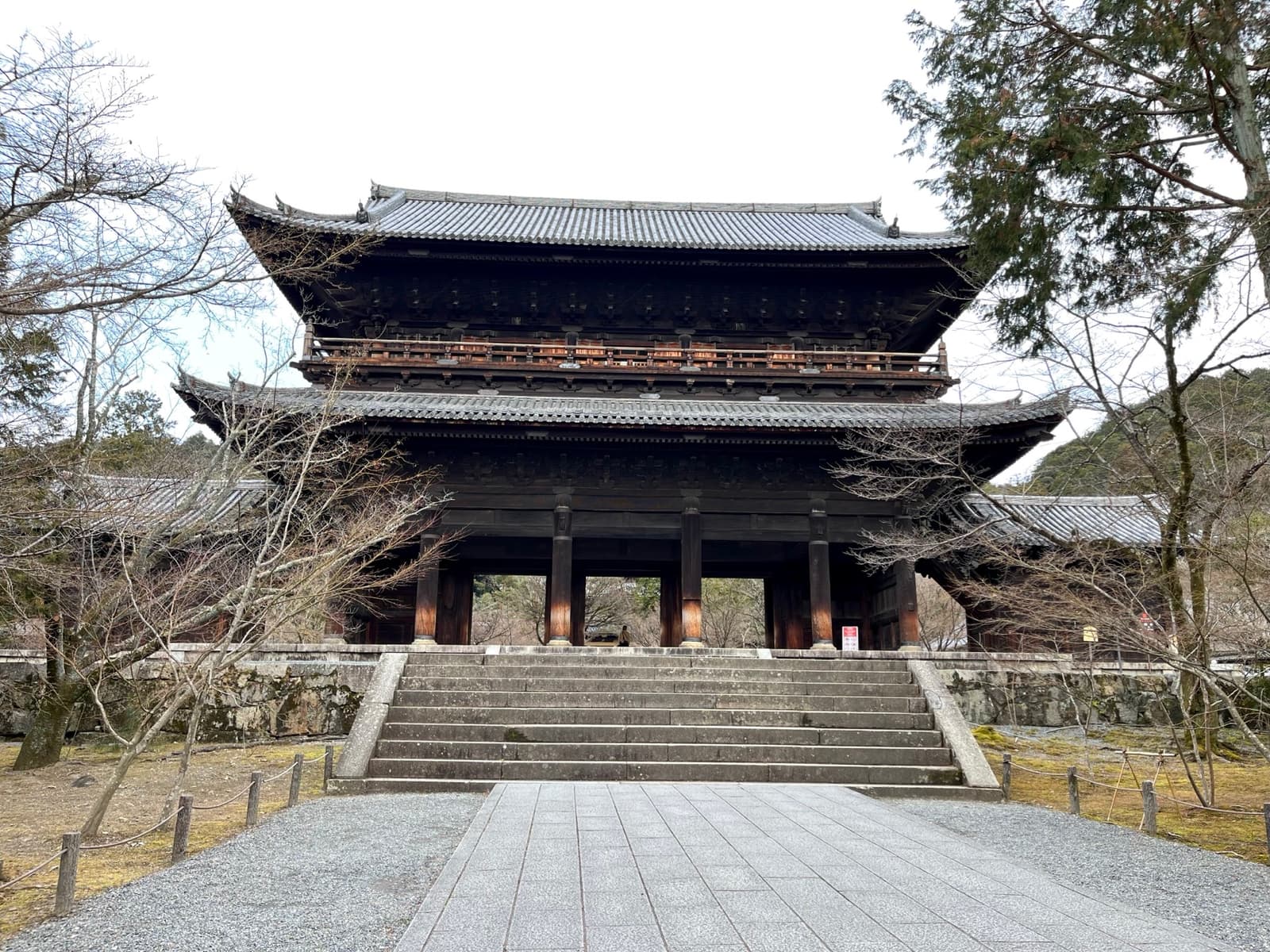 Wide stone steps rising to a vast two-storey wooden gate