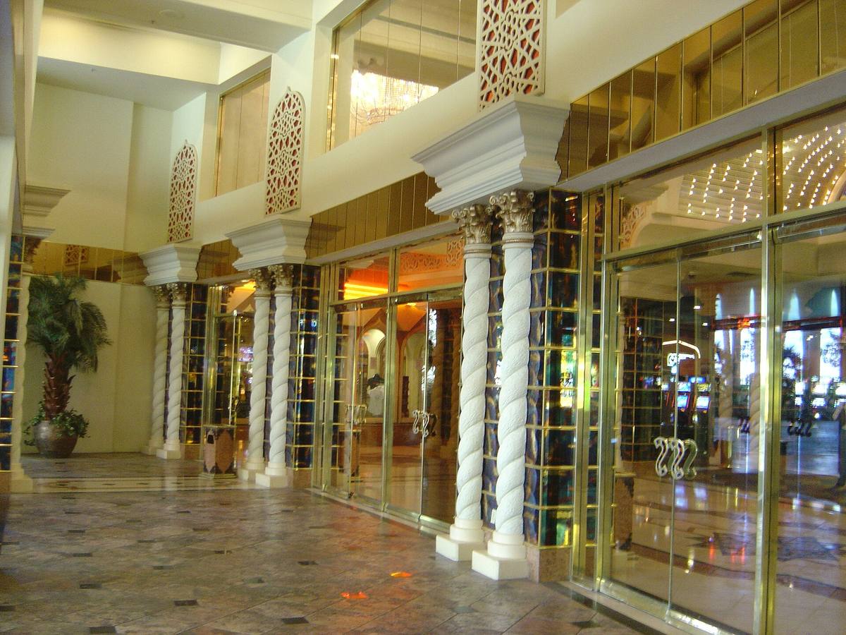 A colonnaded entrance with gold light and Moroccan arches