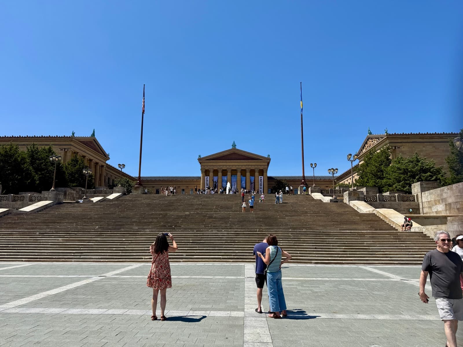 The wide stone steps of the Philadelphia Museum of Art rising to its columned east front under a blue sky