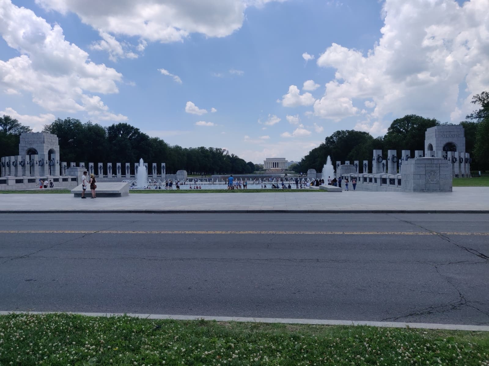 A granite memorial plaza with pillars and a fountain, the Lincoln Memorial beyond