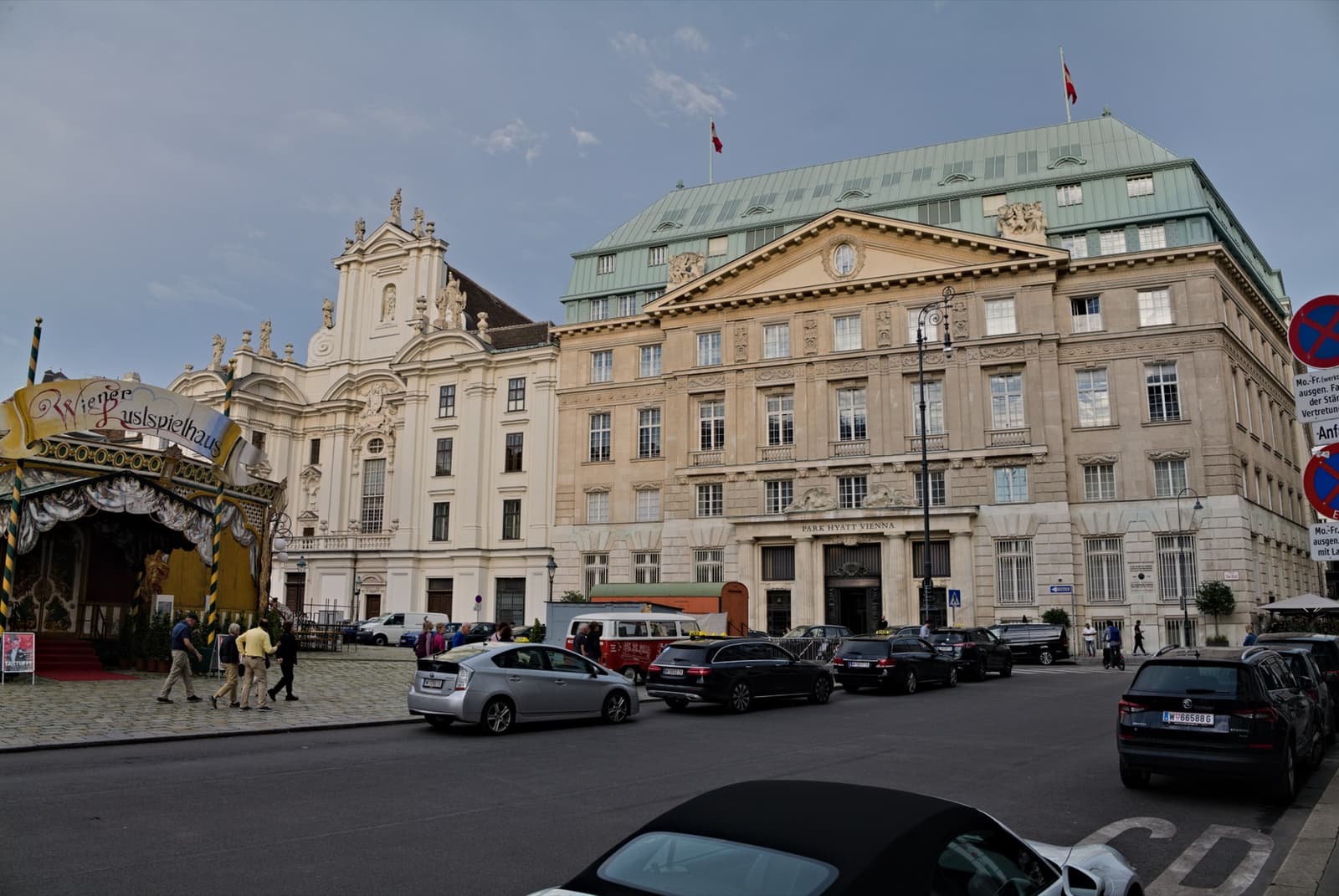 A wide square of old palace fronts under an evening sky