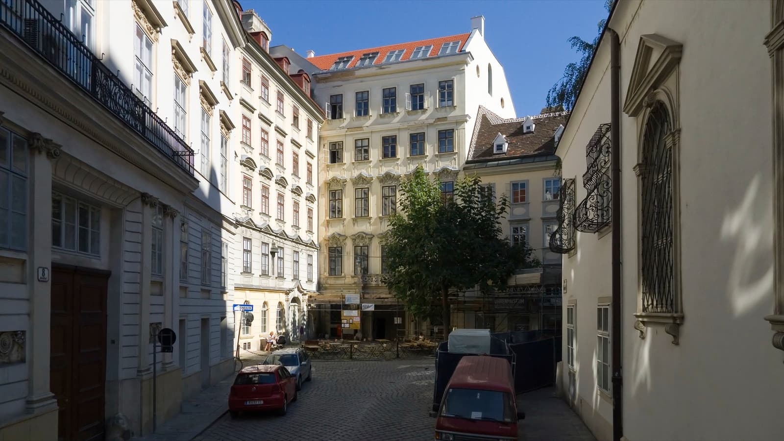 A narrow cobbled lane between pale old houses