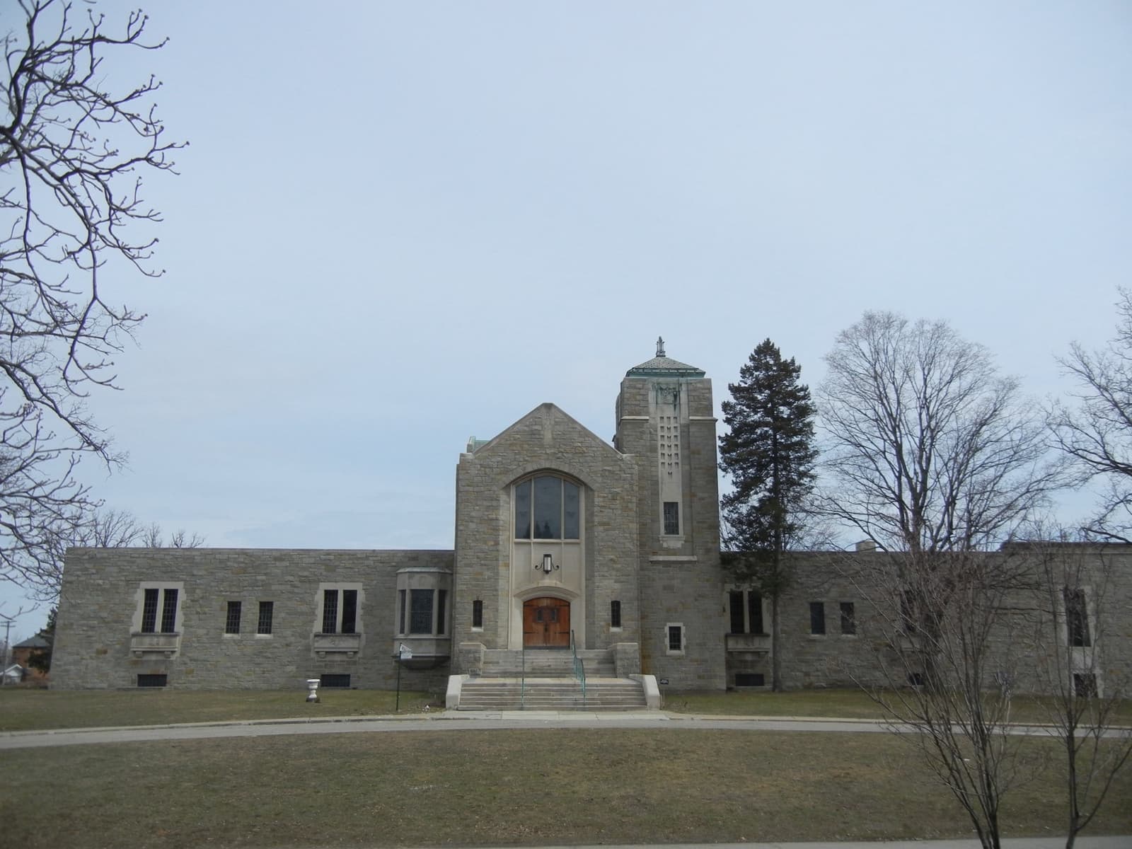 A stone mausoleum among trees at Woodlawn Cemetery in Detroit