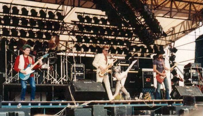 A festival crowd in front of a lit stage at Donington Park, 1982