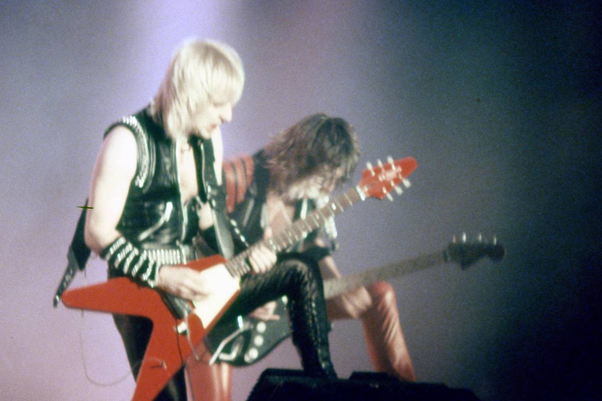 K. K. Downing and Glenn Tipton playing guitars side by side on stage in 1984