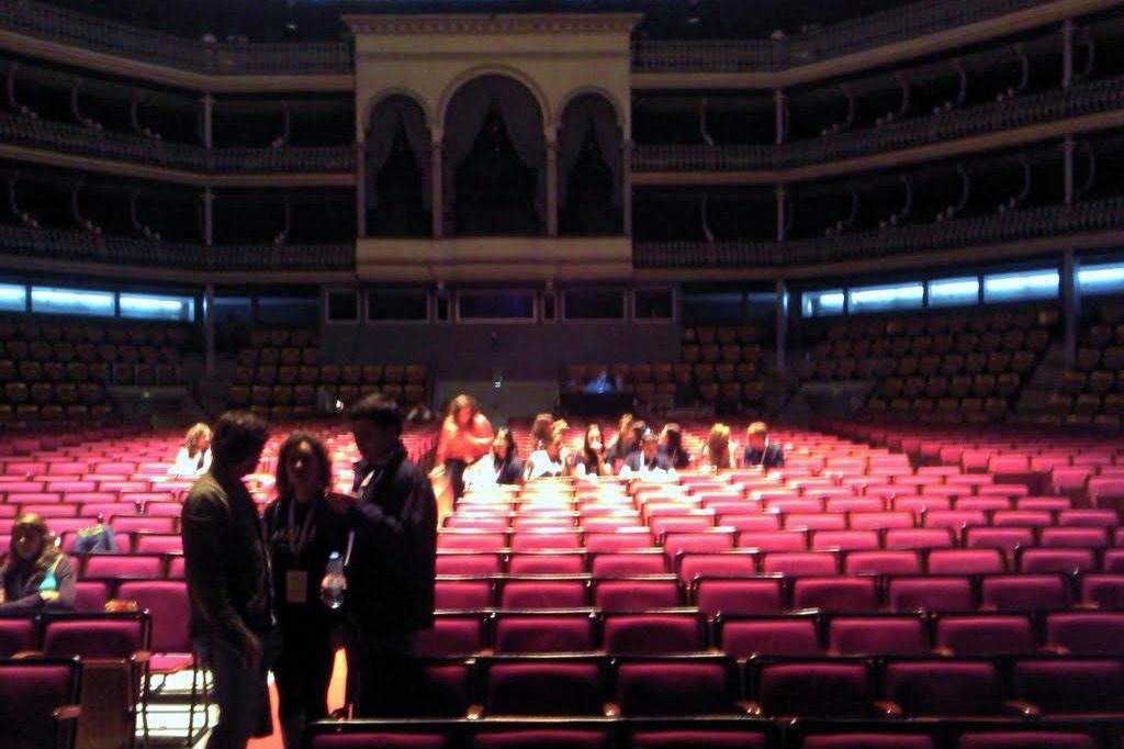 Rows of red seats under the galleries of the Coliseu in Lisbon