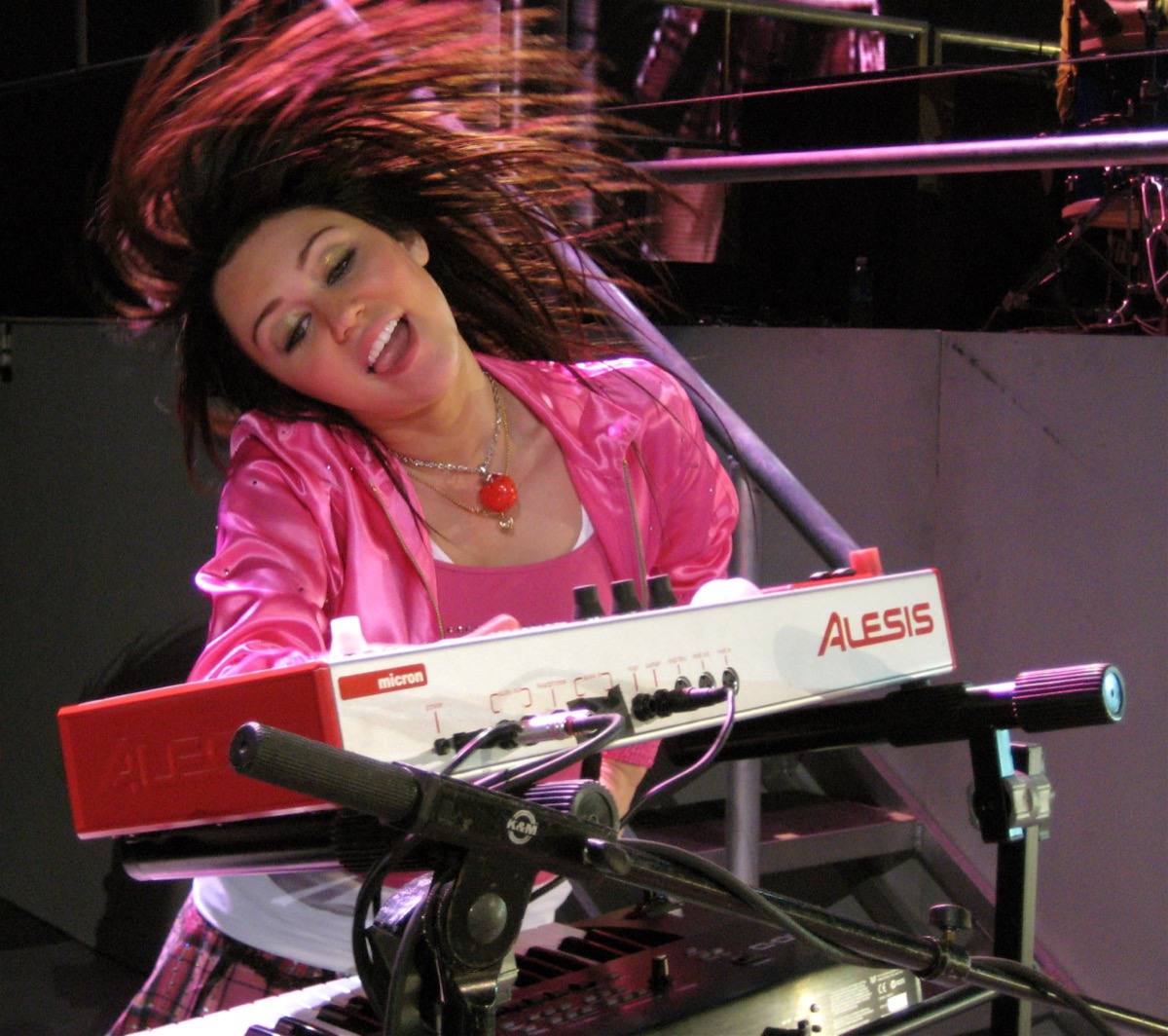 Miley Cyrus singing on a concert stage in 2008