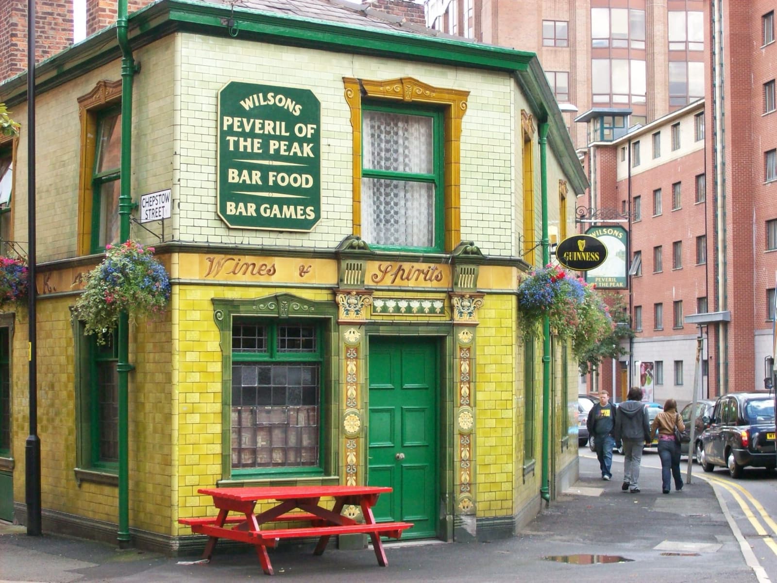 A small wedge-shaped pub clad in green tiles