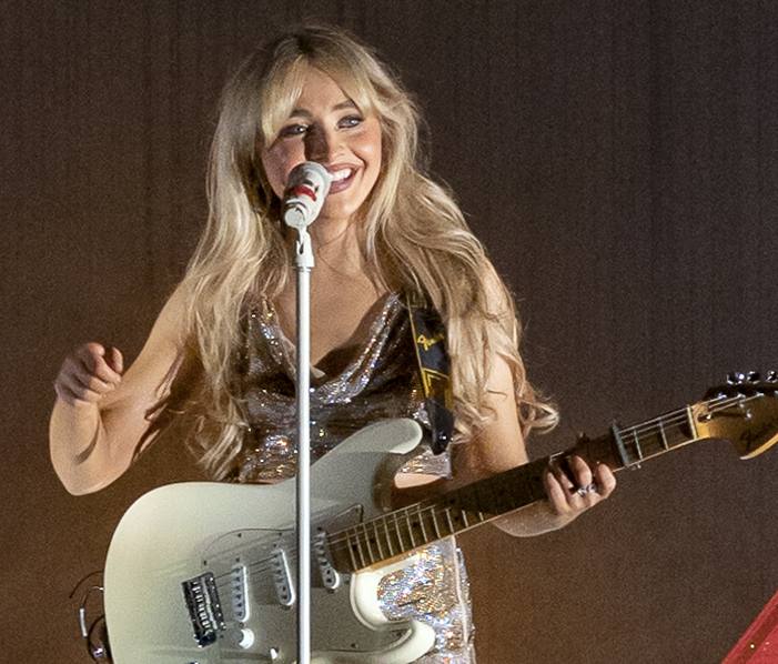 Sabrina Carpenter singing on stage in 2022