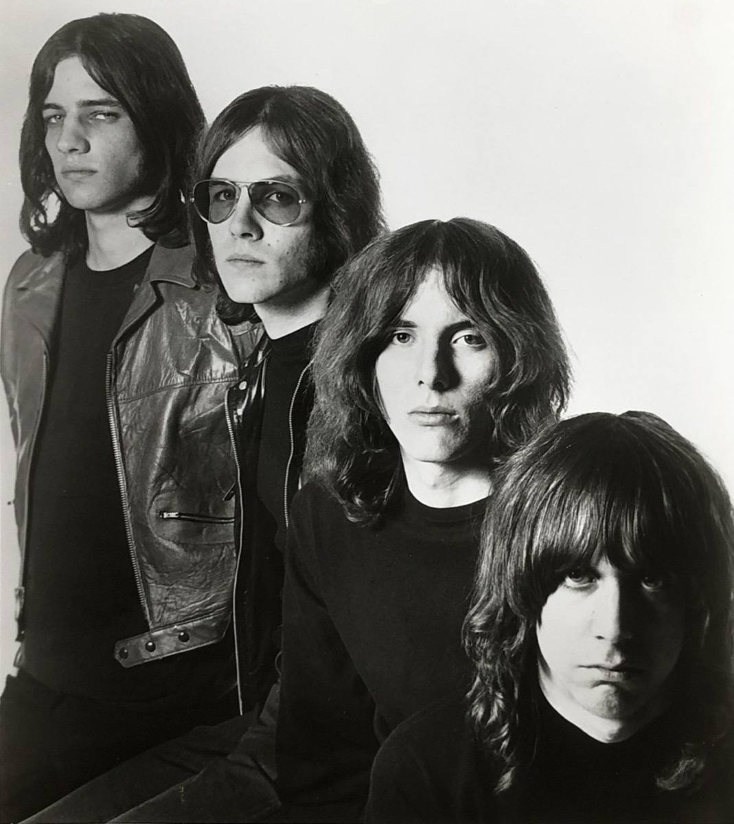 The four Stooges in black and white in 1969, long hair and leather, faces close together
