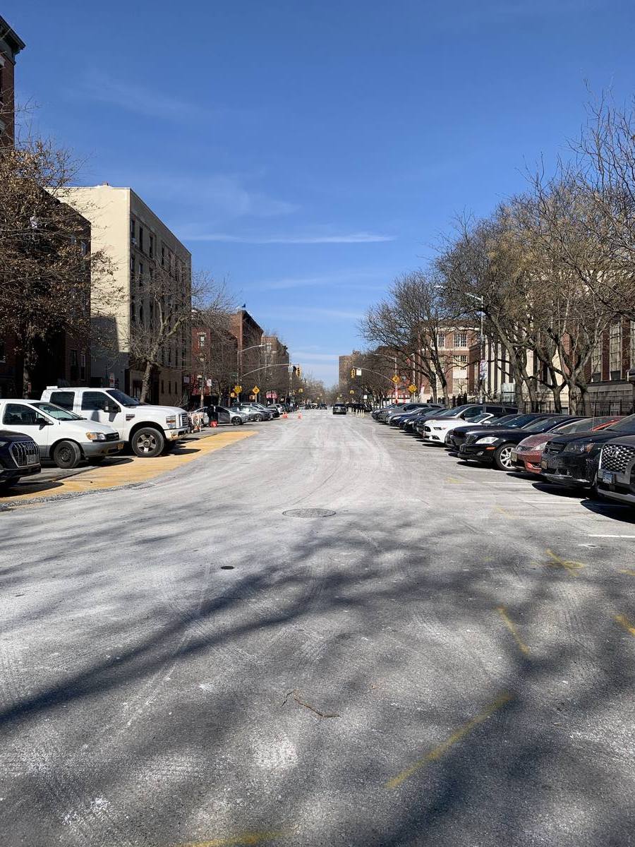 A street of brick tenements in East Harlem