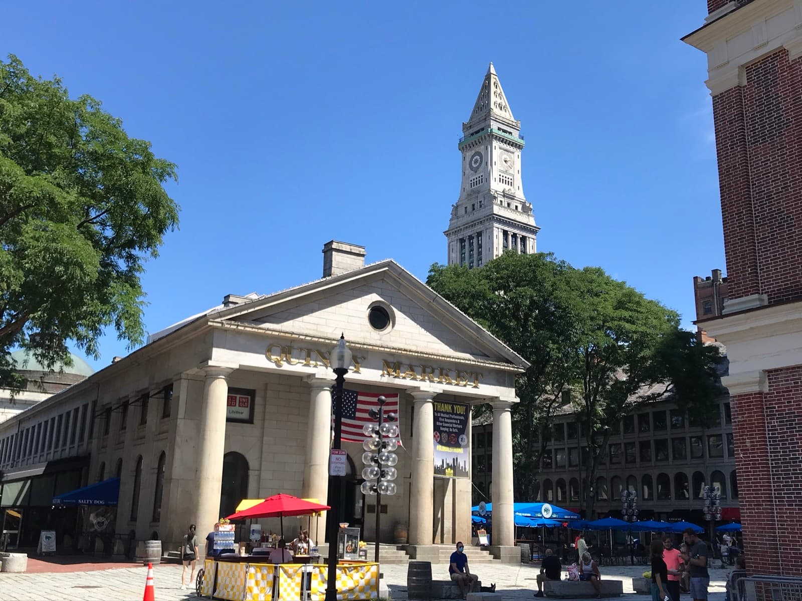 The columned granite front of Quincy Market under a blue sky, the Custom House tower behind