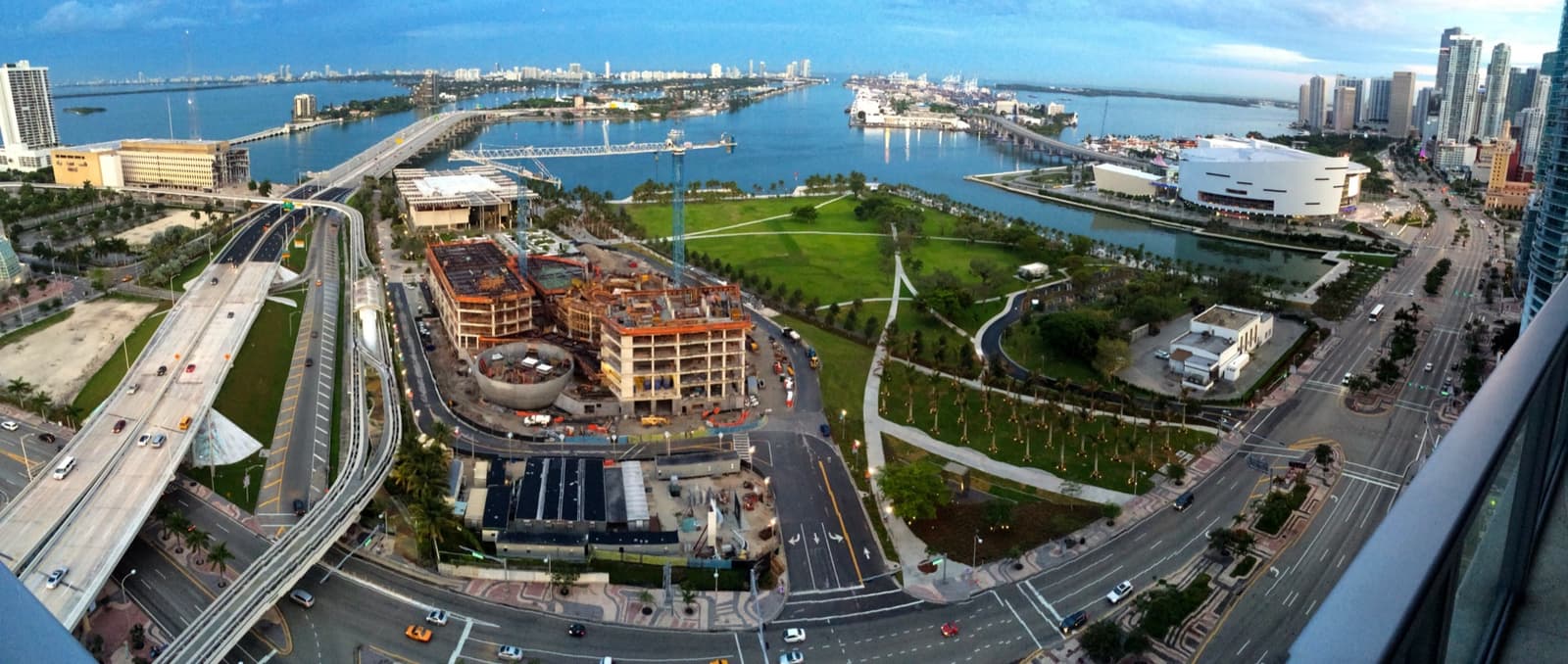An aerial view of a bayfront park beside downtown Miami and the port