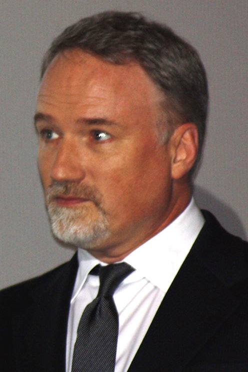 David Fincher in glasses and a dark coat