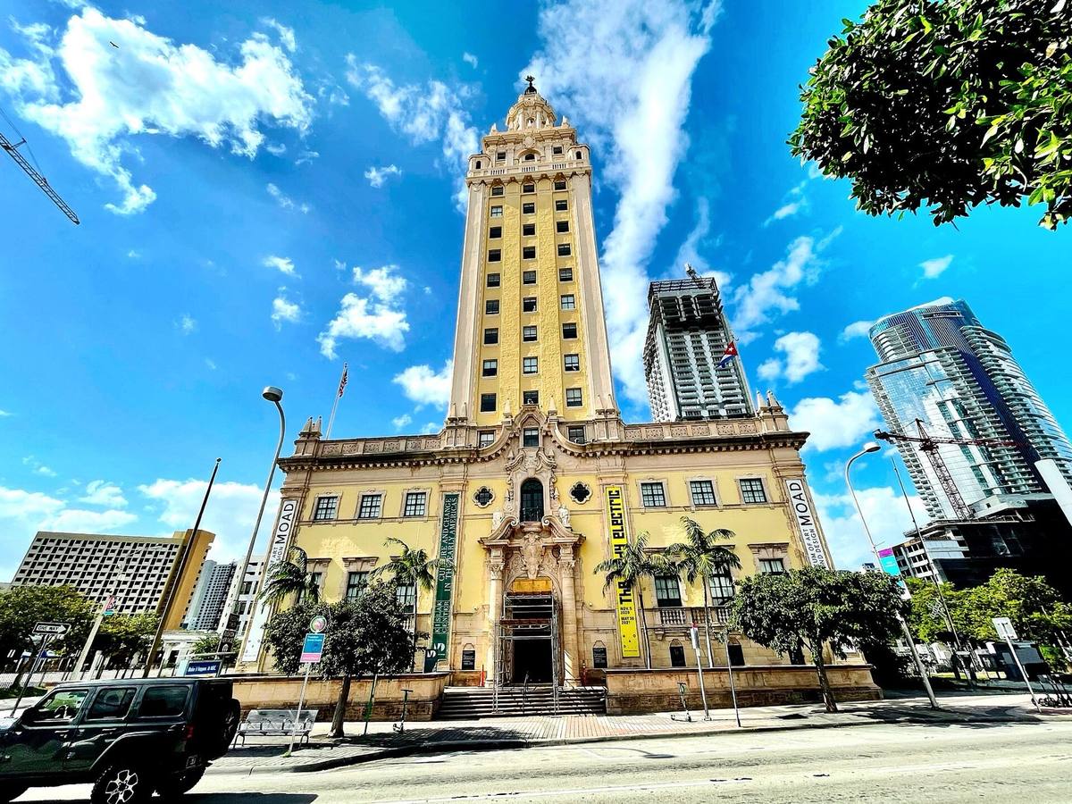 A cream Spanish Revival tower under a blue sky