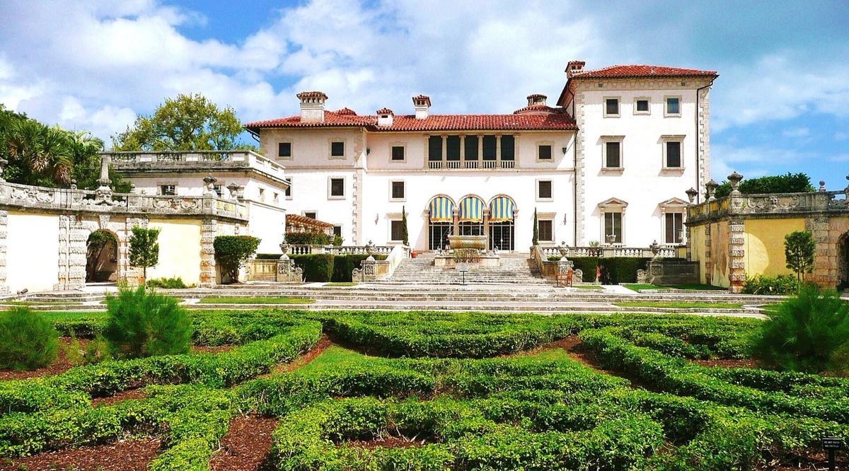 A cream Italianate villa above clipped parterre gardens