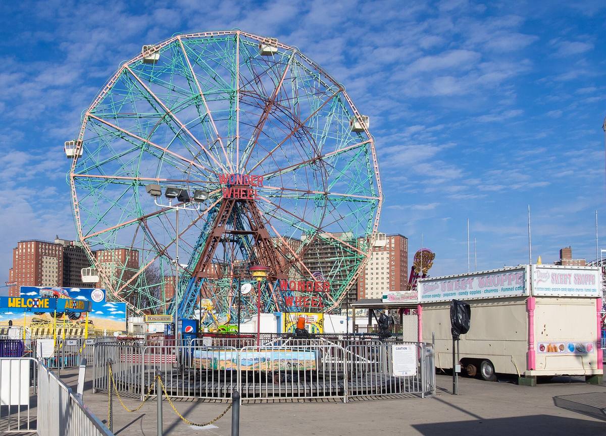 The Wonder Wheel against a blue sky, its gates shut for winter