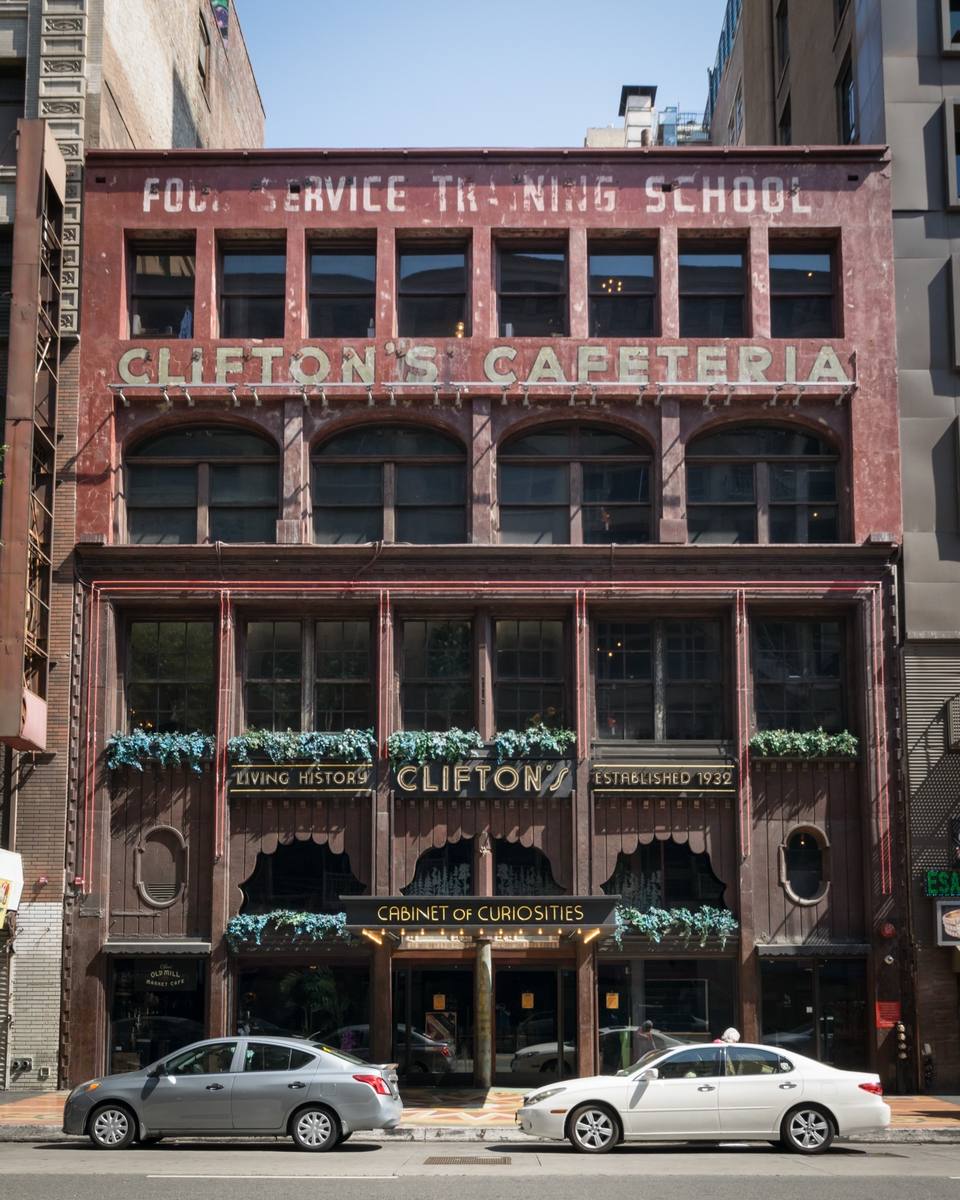 A narrow red-brick building front with Clifton's Cafeteria lettered across it