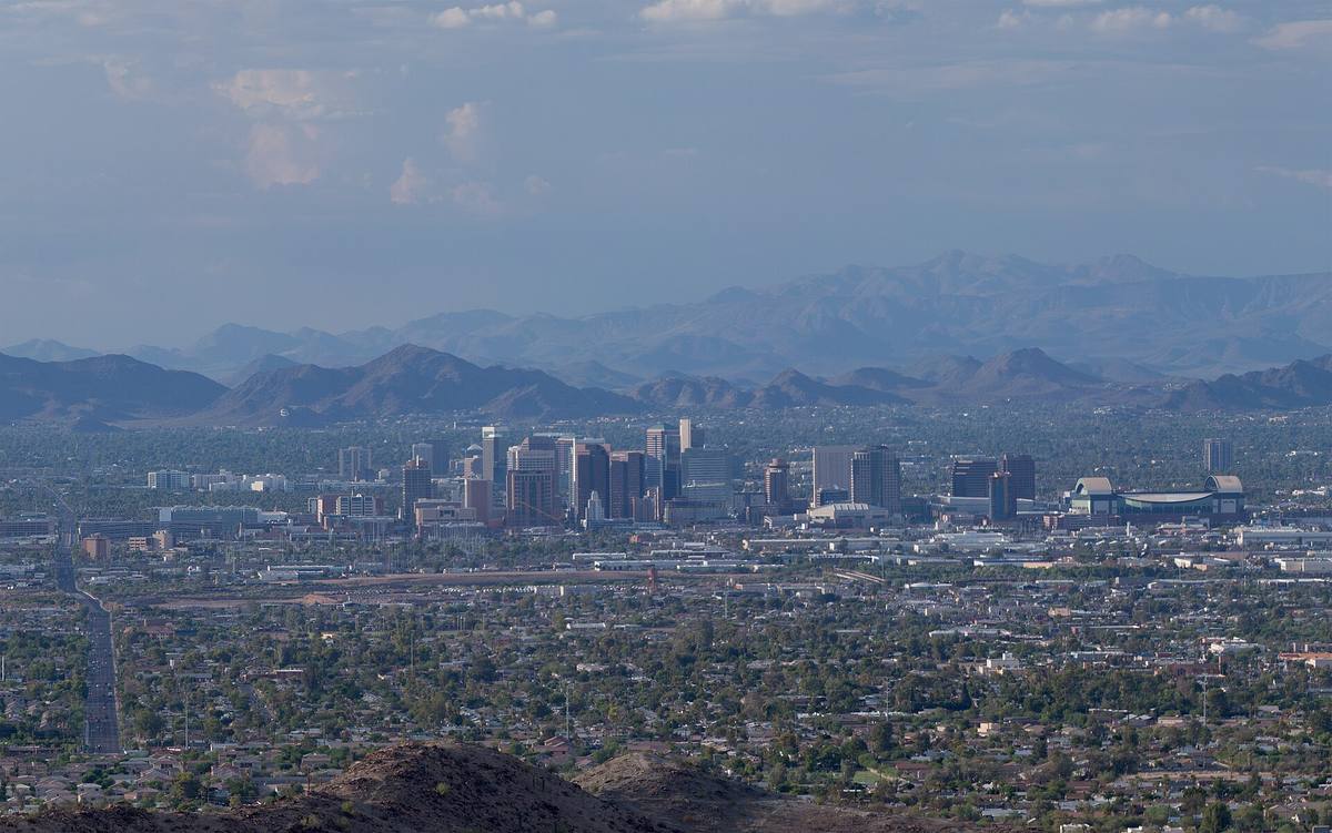 Office towers of downtown Phoenix against desert mountains