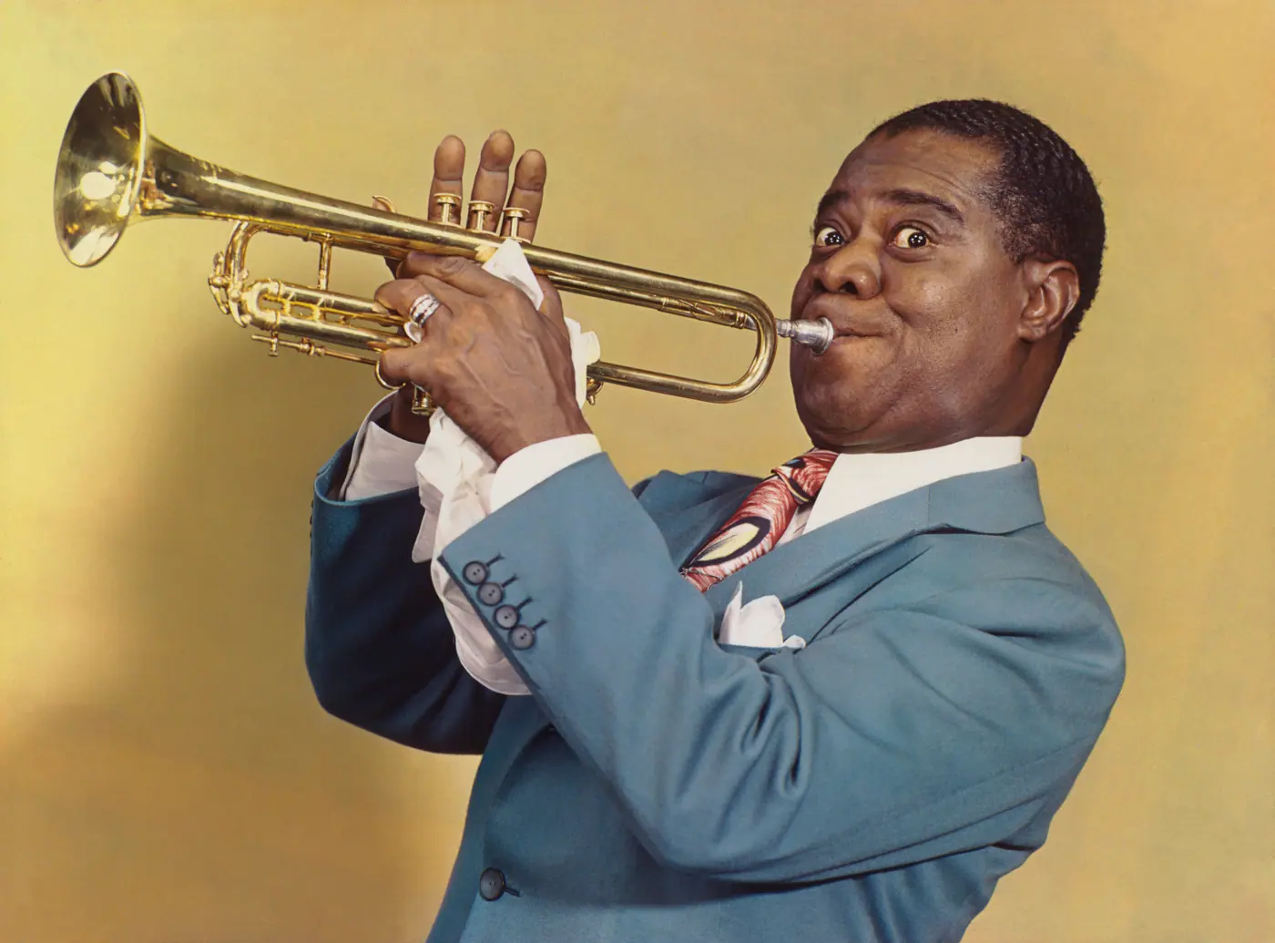 Louis Armstrong playing trumpet in a 1947 colour portrait