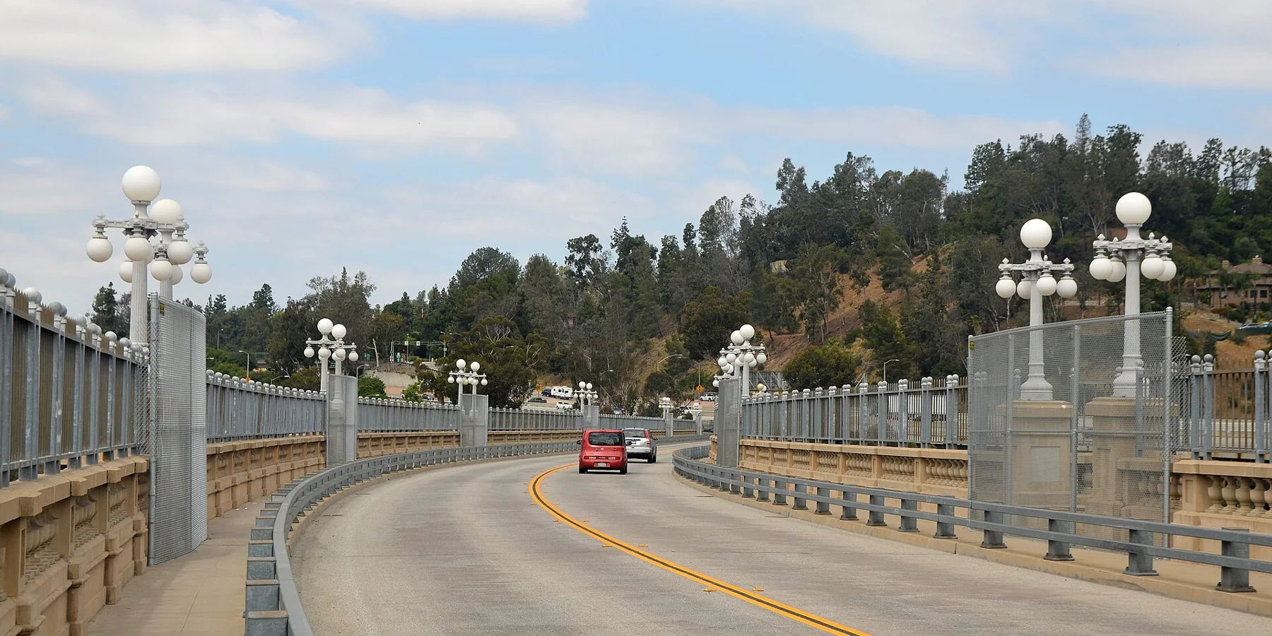 Ornate lamps and railings along the curving Colorado Street Bridge.