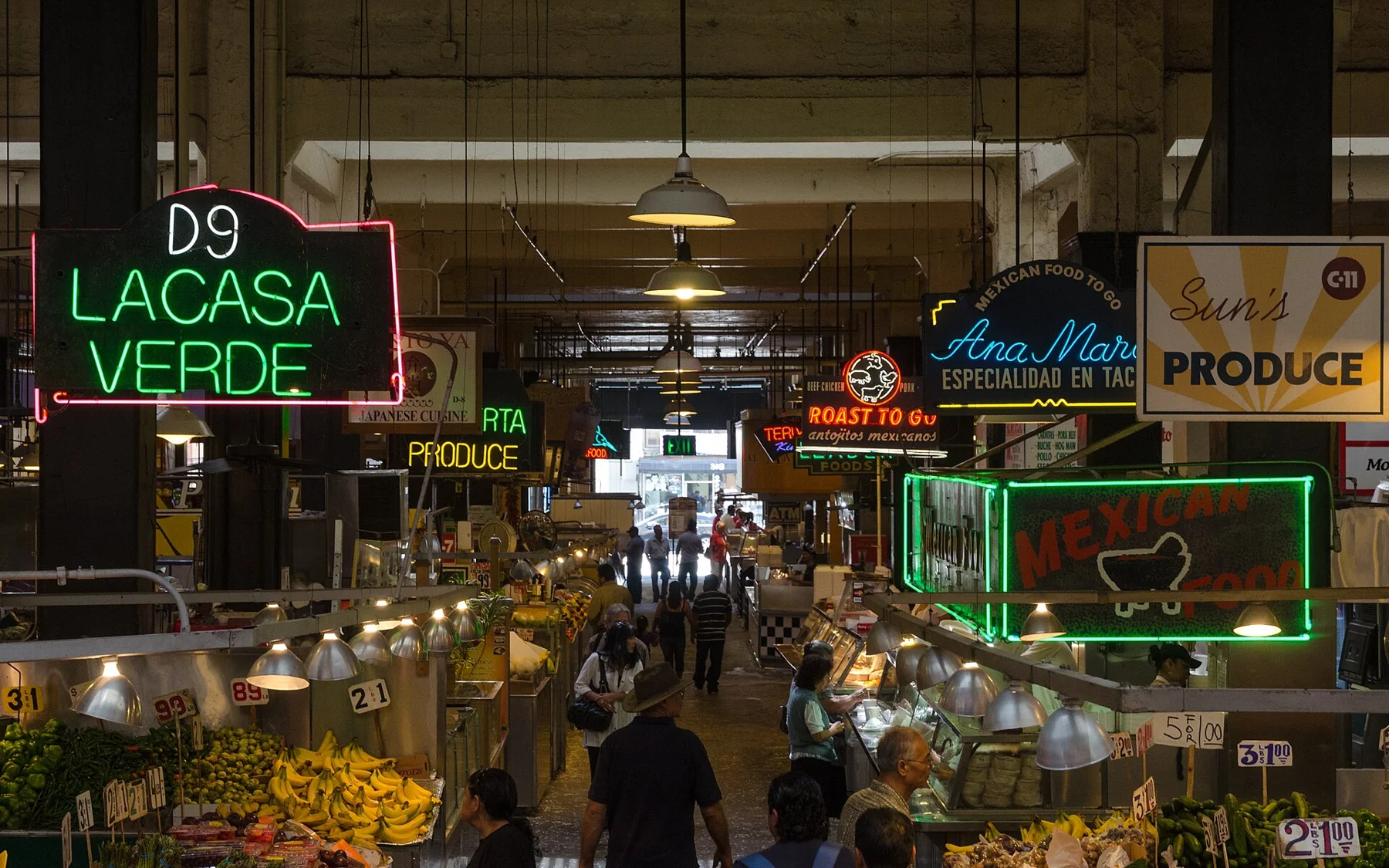Neon signs above the busy aisles of Grand Central Market.