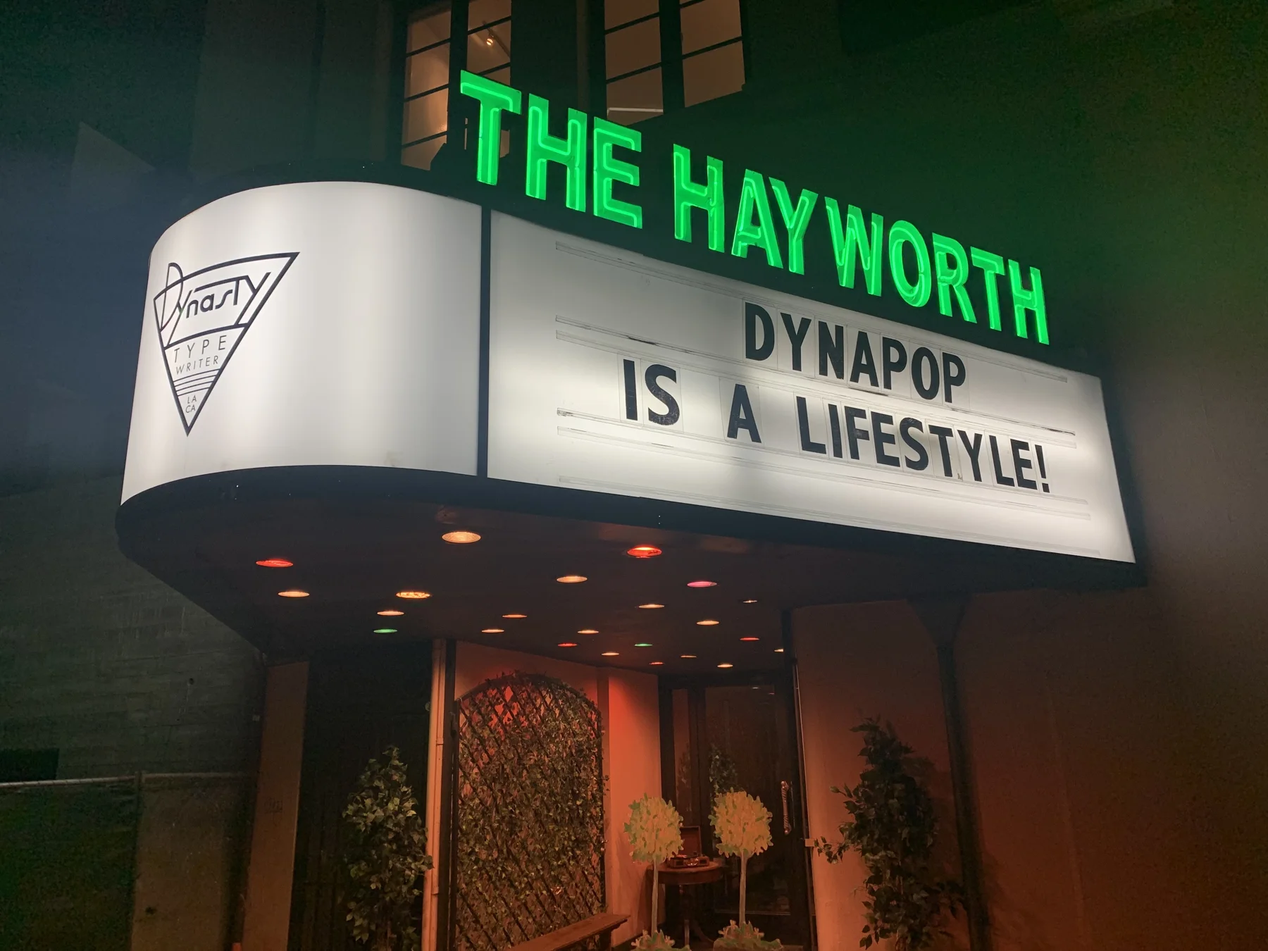 The Hayworth Theatre marquee lit at night.