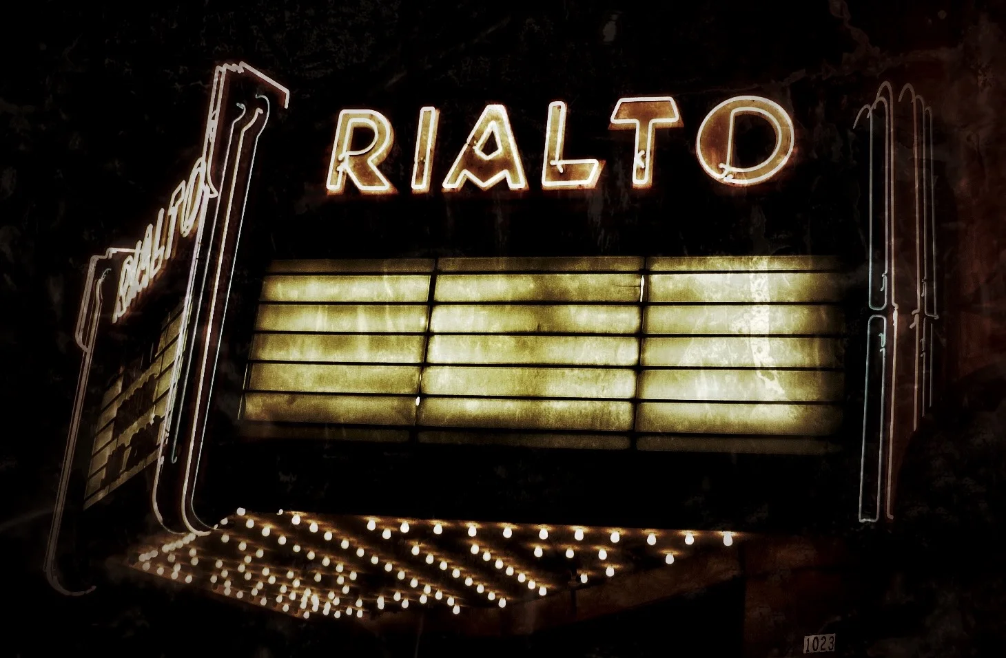 The Rialto Theatre marquee illuminated at night.